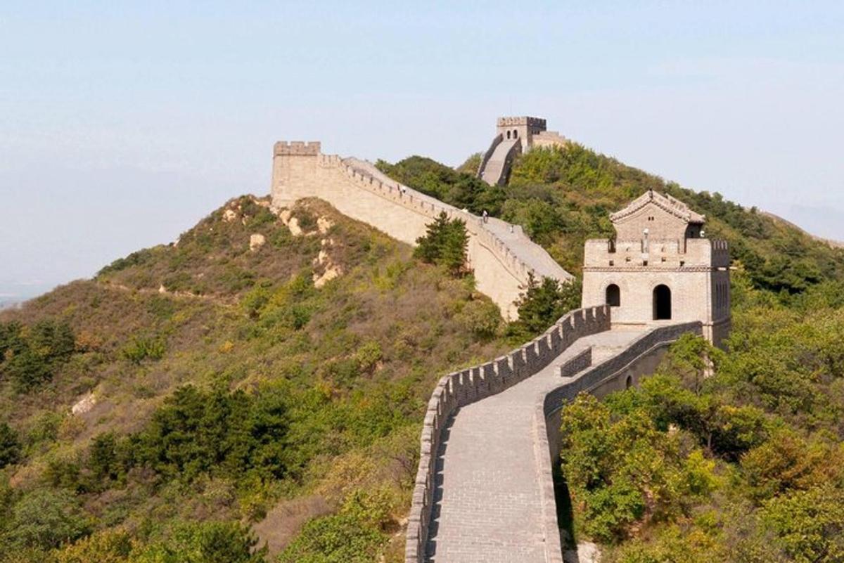 a wall on a hill with a building on it