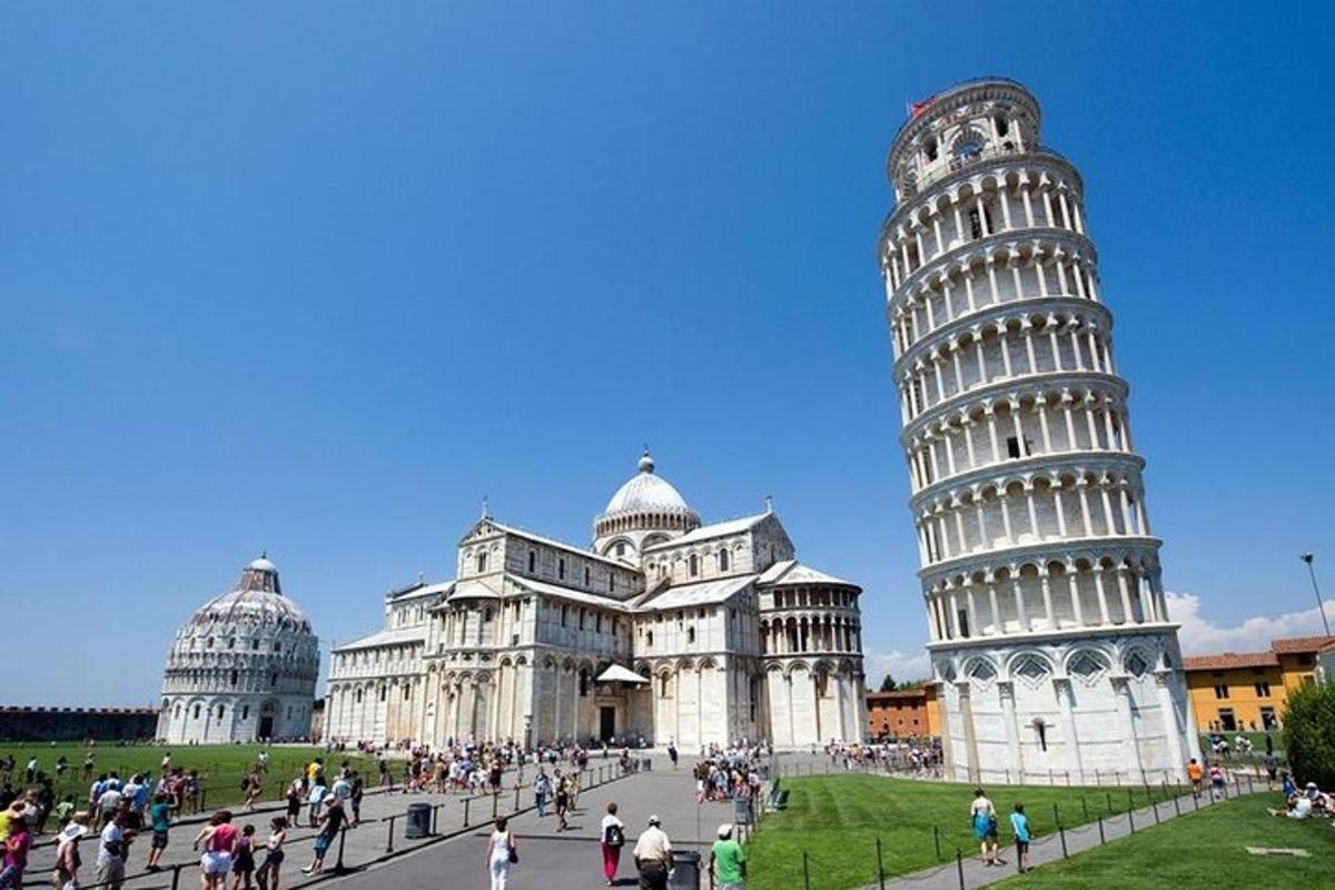 a group of people walking around the leaning tower of pisa