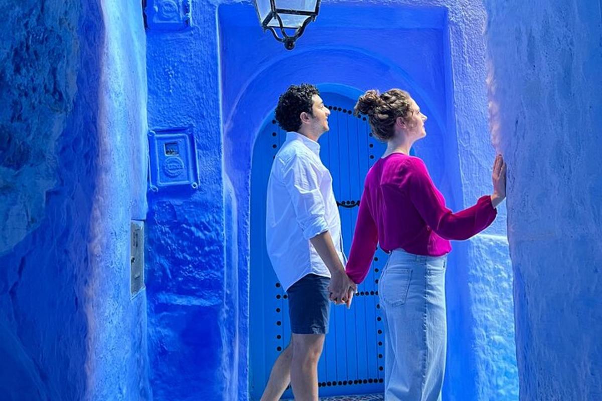 a man and a woman standing in a blue room
