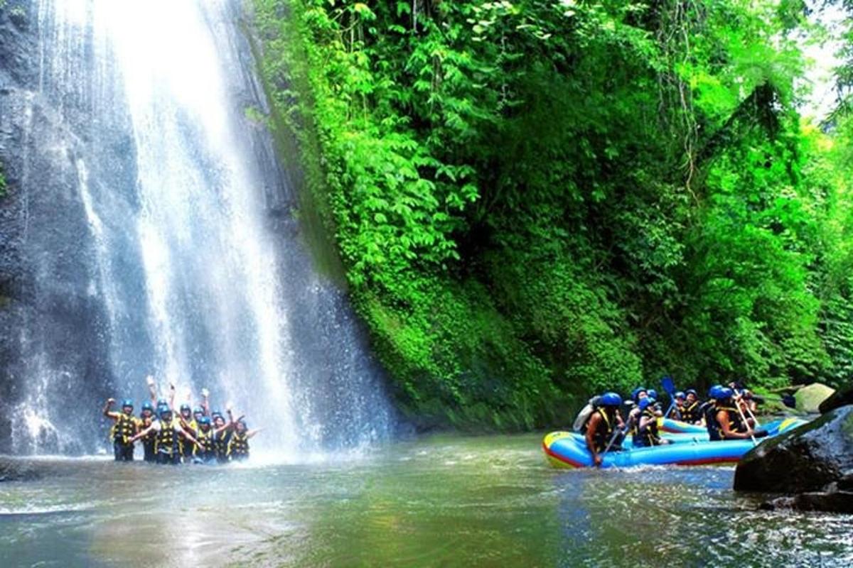 a group of people on a raft in front of a waterfall