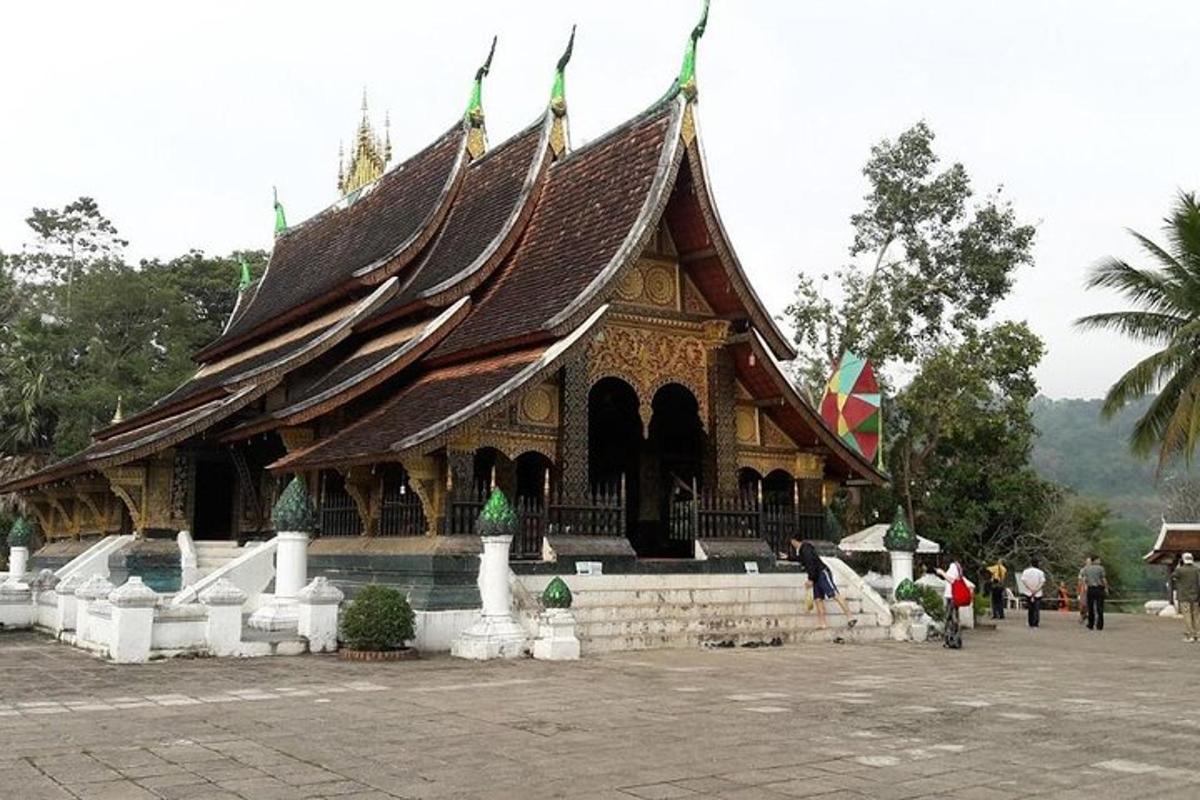 a large building with a roof with people standing around it