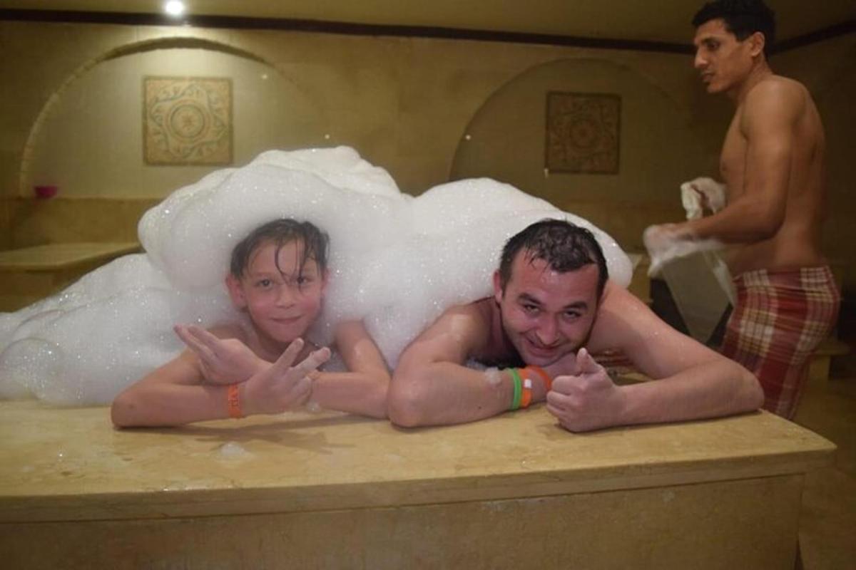due persone in un bagno di schiuma in una vasca