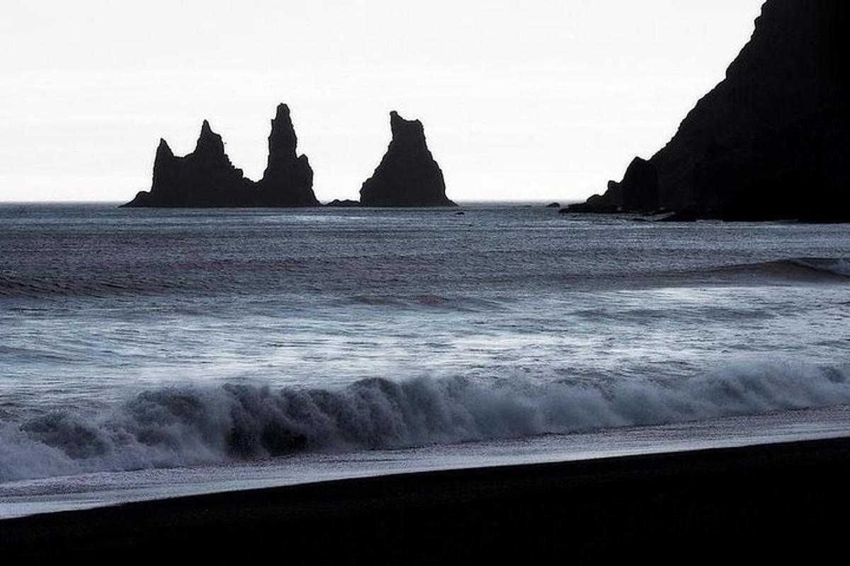 un gruppo di rocce nell'oceano con una spiaggia