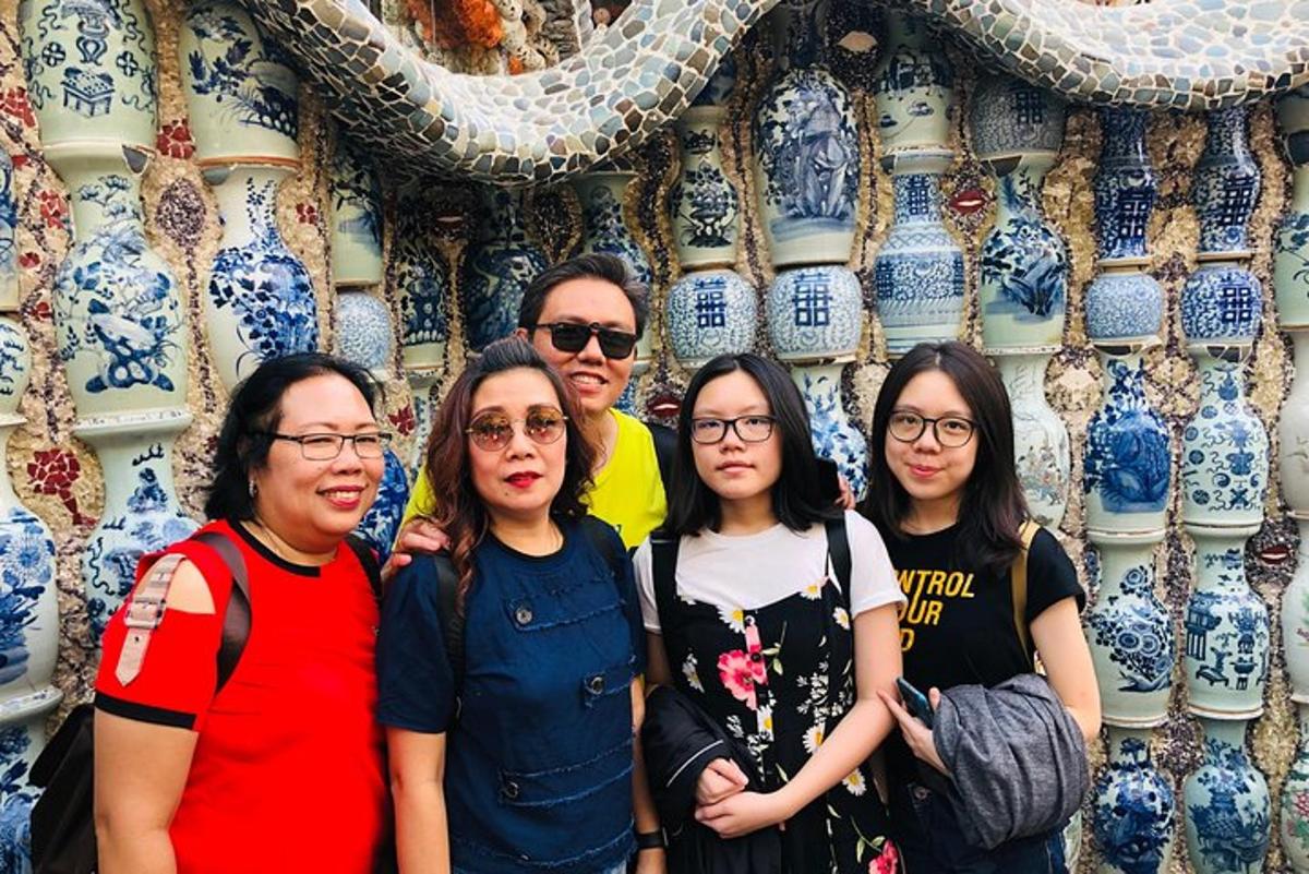 a group of people standing in front of a wall of vases