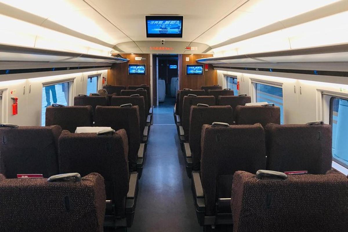 a train car with empty seats and a television