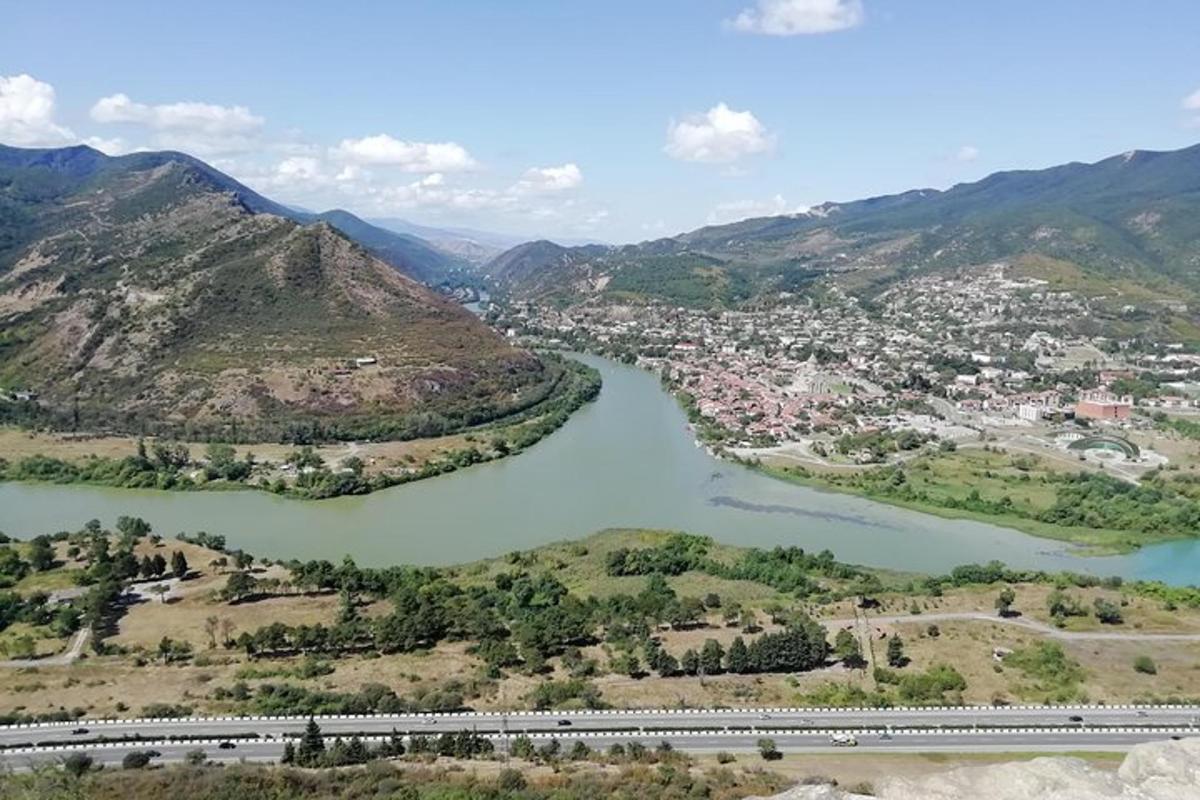arial view of a river with a city and a train