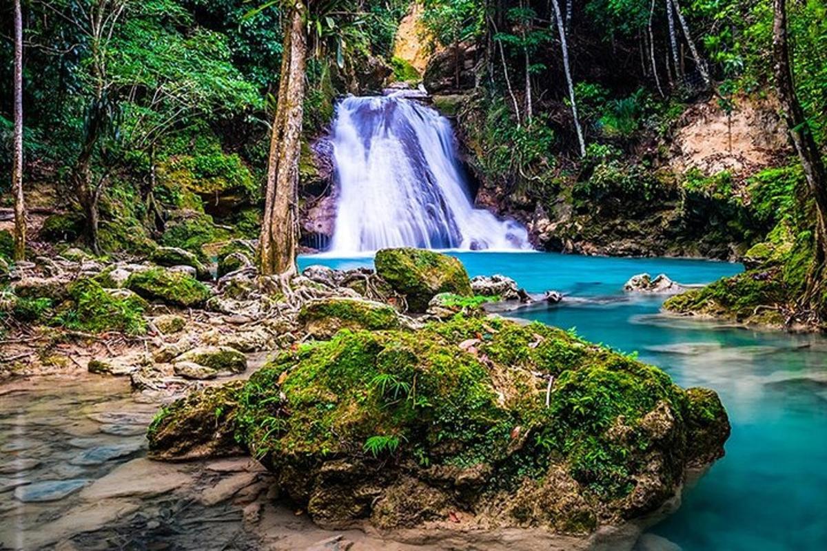 a waterfall in the middle of a river with rocks