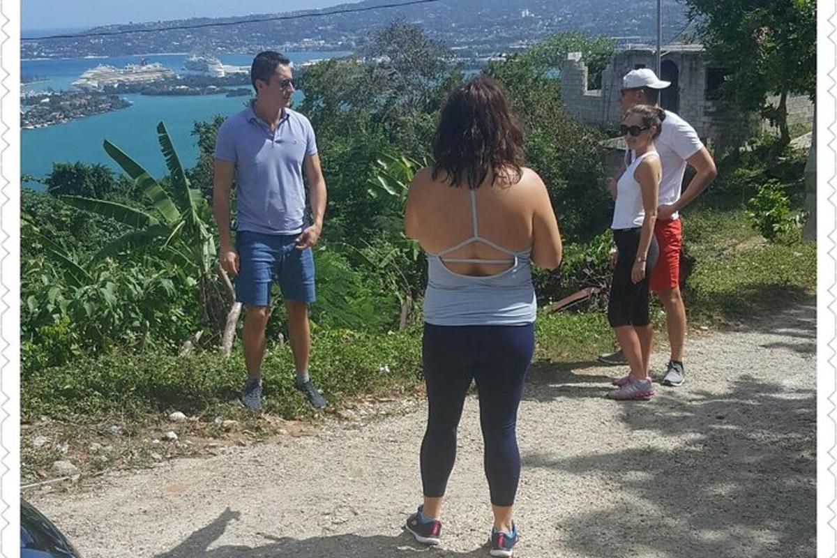 a group of people standing on a dirt road