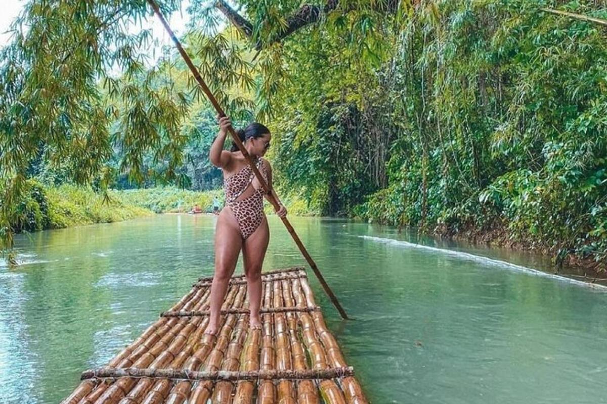 a woman in a bikini standing on a raft in a river