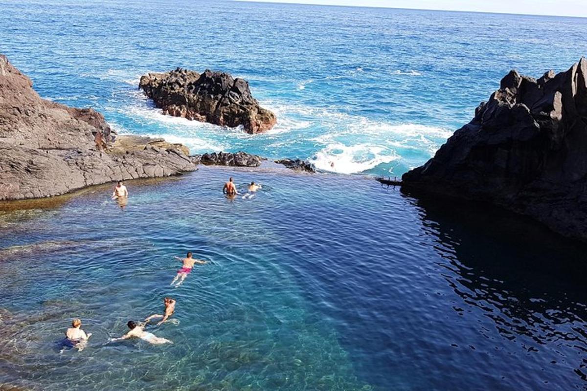 a group of people swimming in the ocean
