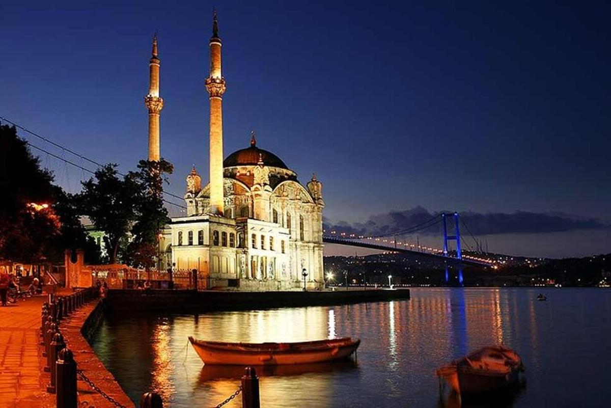 a building with a mosque with a bridge in the background
