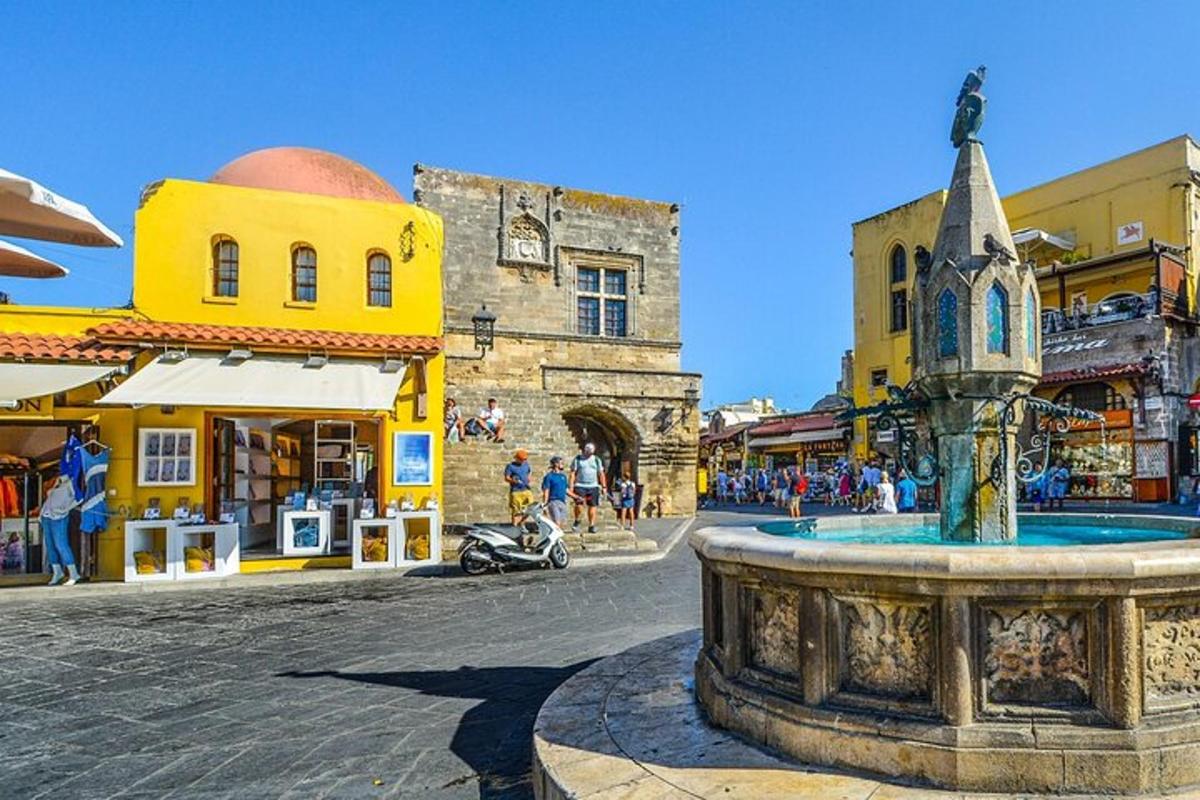 a town with a fountain in the middle of a street
