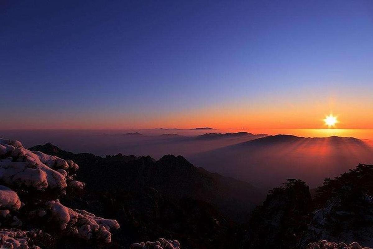 a sunset on the top of a mountain