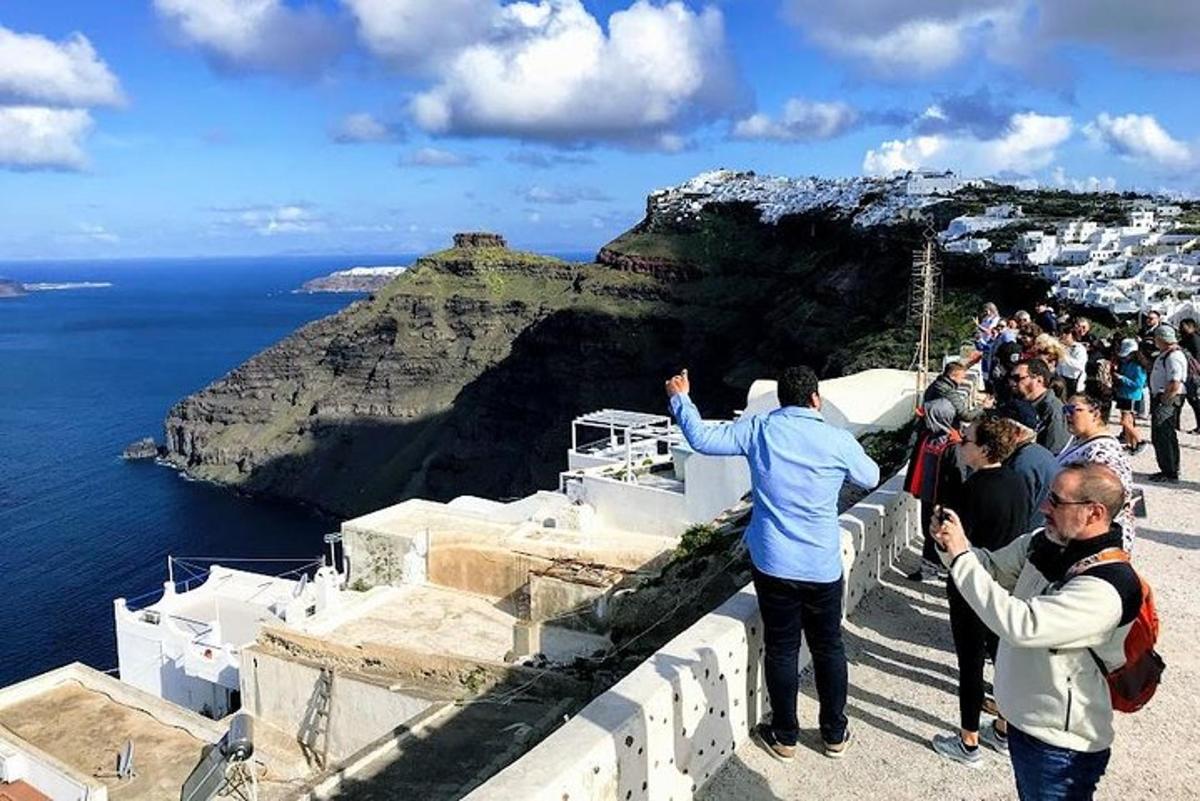a crowd of people taking pictures of the ocean