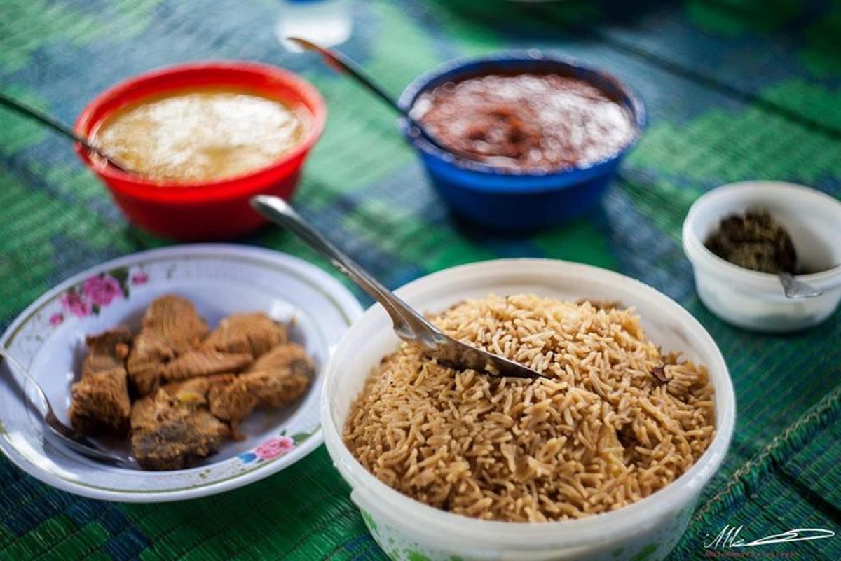 a table topped with bowls of rice and food