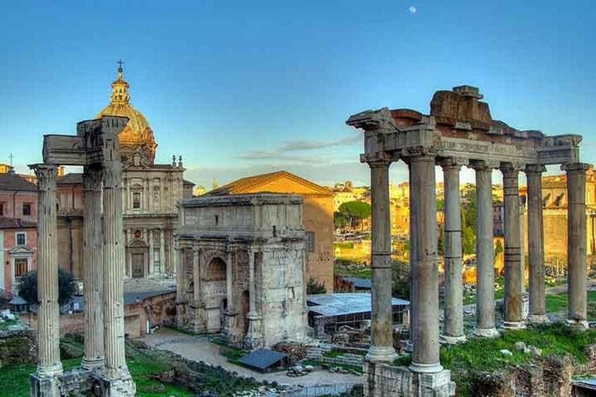 an ancient building with columns in front of a building