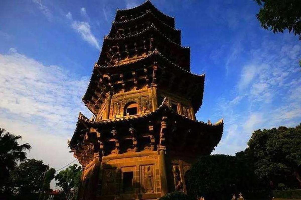 a large tall tower with a blue sky in the background