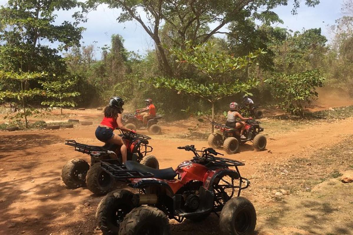 a group of people riding atvs on a dirt road