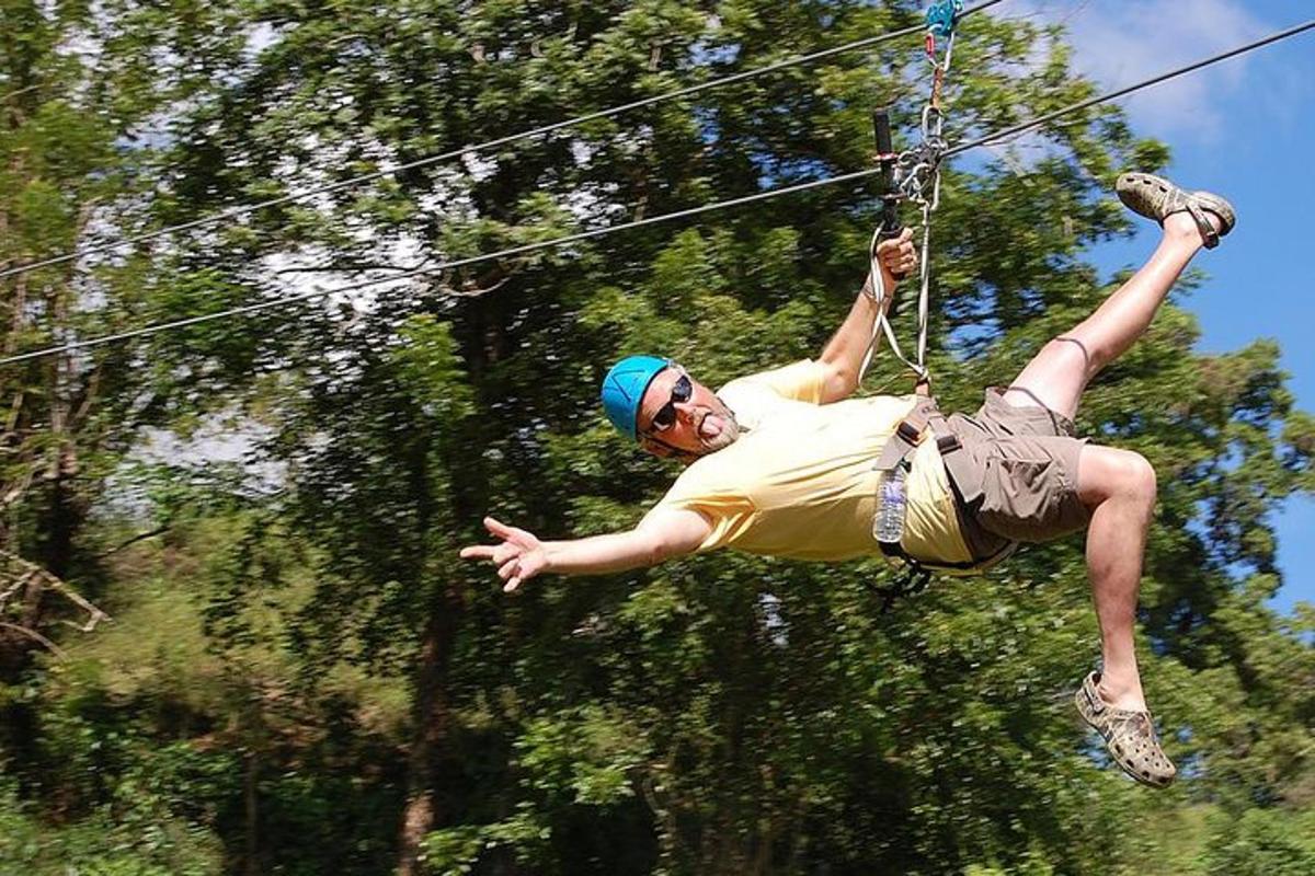 a man is hanging on a zip line