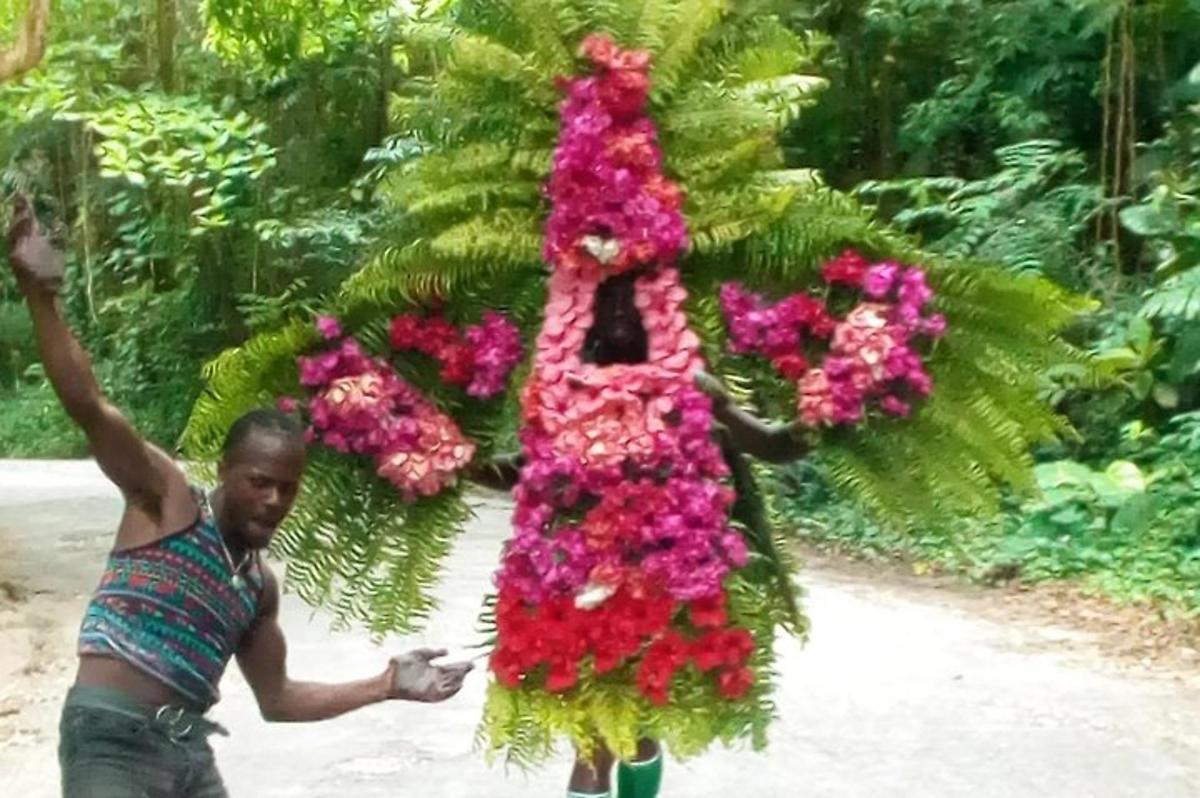 a man is carrying a bunch of flowers