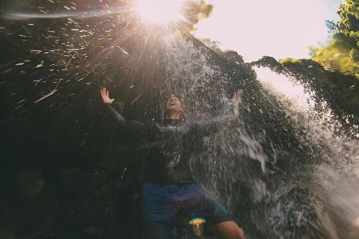 a woman standing in the water with her hands up