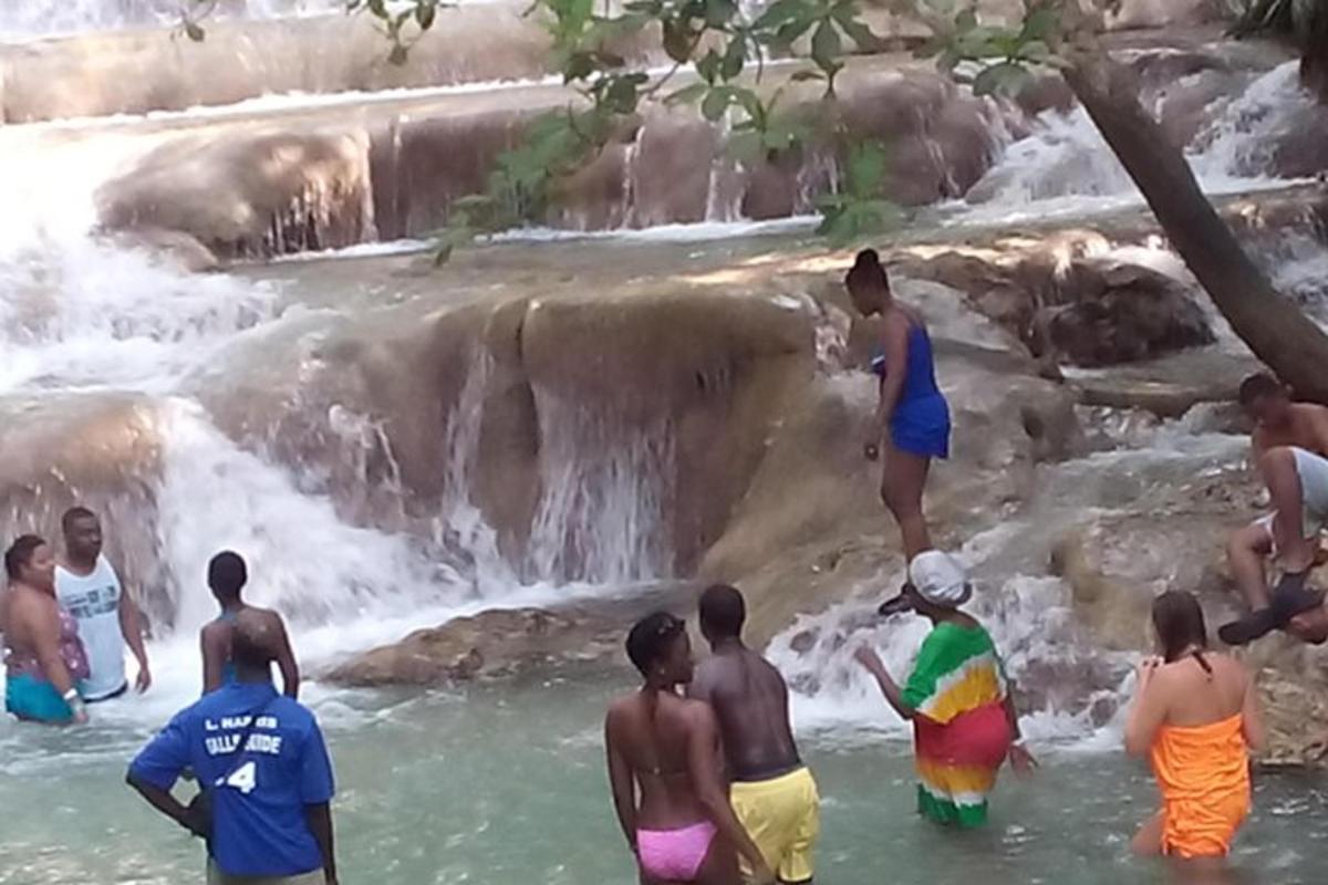 un gruppo di persone in acqua vicino a una cascata