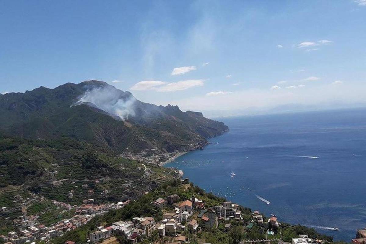 a view of a mountain next to the ocean