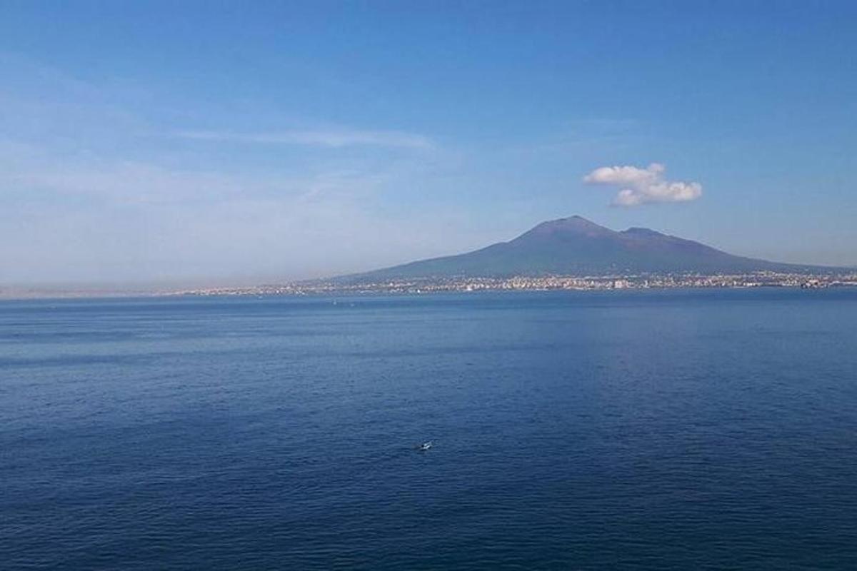 a large body of water with a mountain in the background