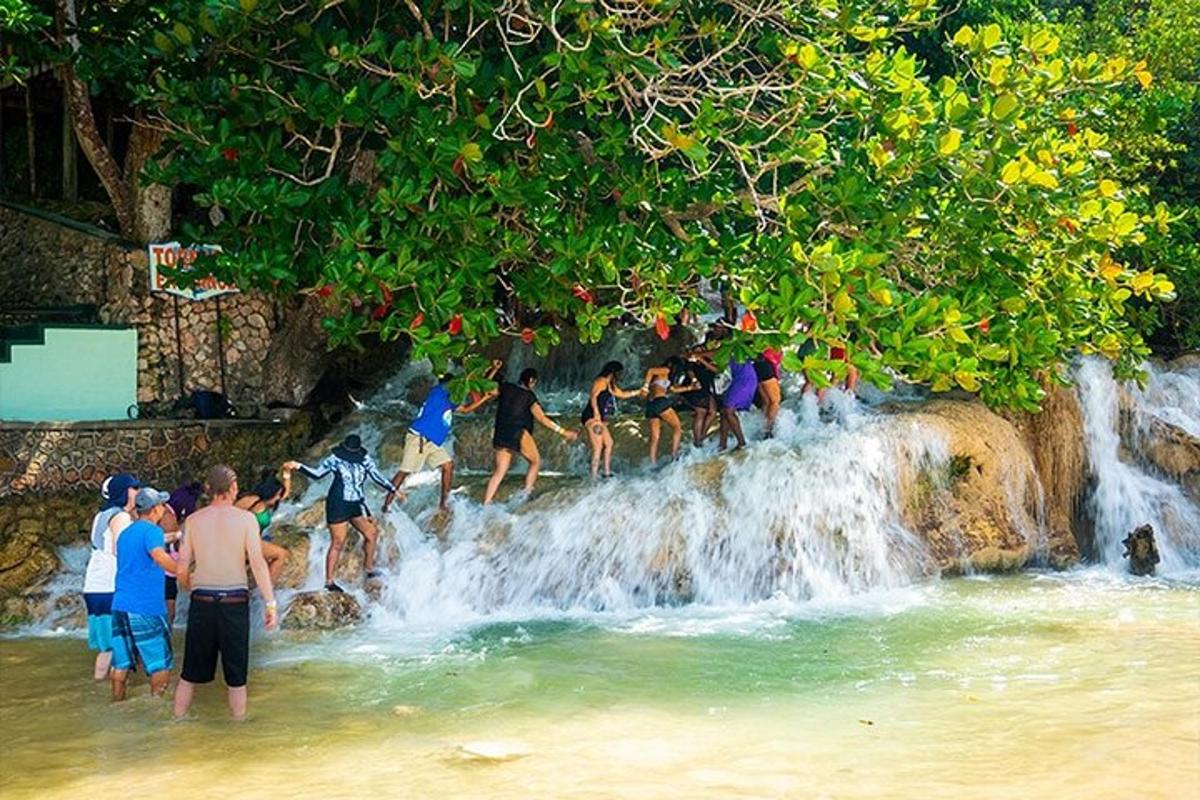 a group of people standing on top of a waterfall