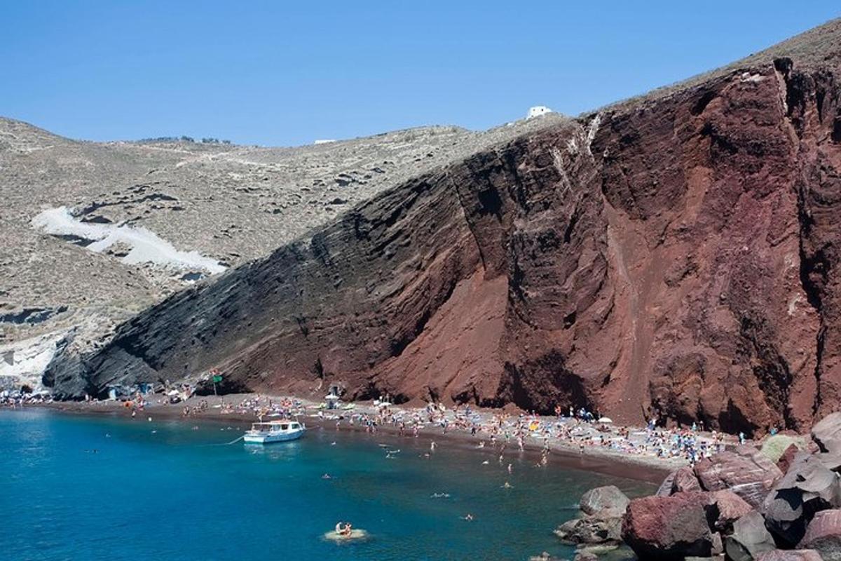 hópur fólks á strönd við fjall