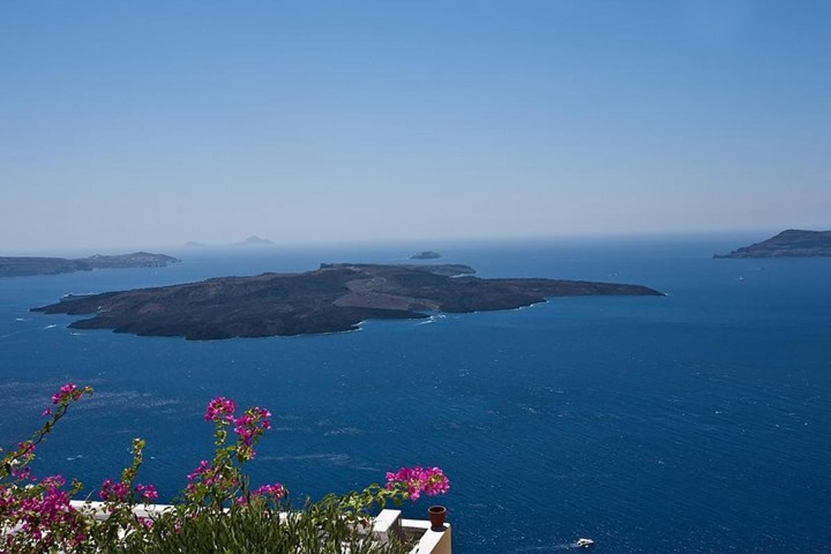 osoba sediaca na stoličke a pozerajúca sa na oceán