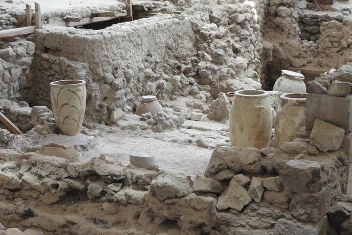 μια ομάδα αγγείων που κάθονται σε έναν πέτρινο τοίχο