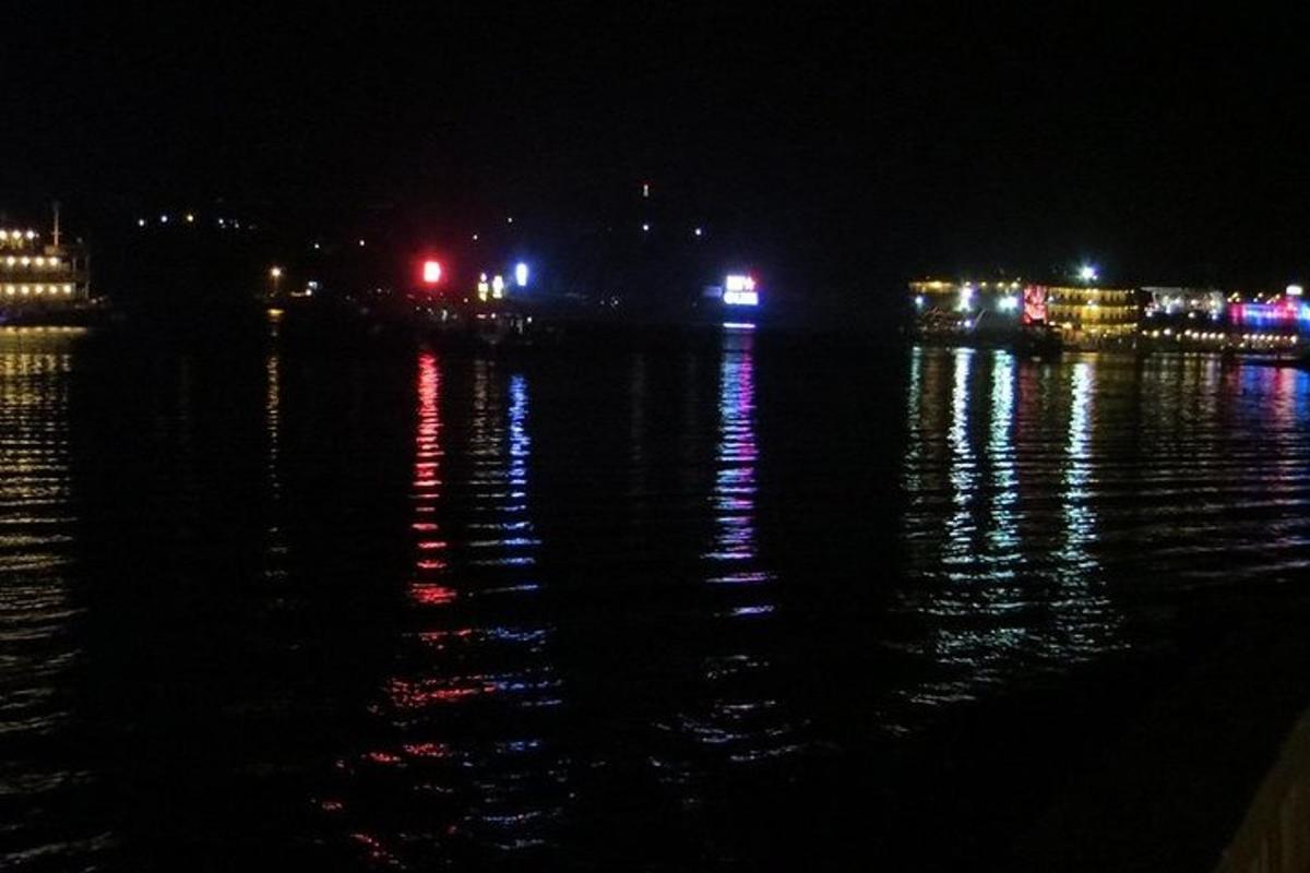 a body of water at night with lights on the water