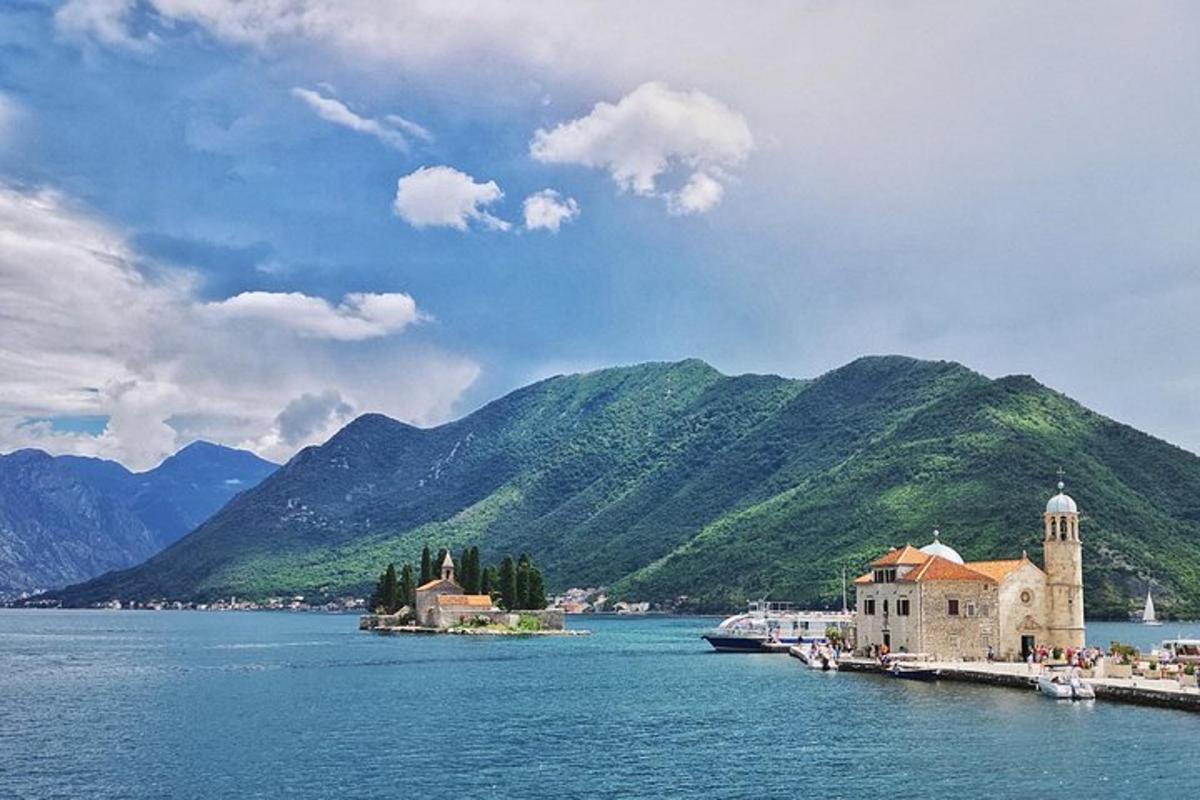 a large body of water with mountains in the background