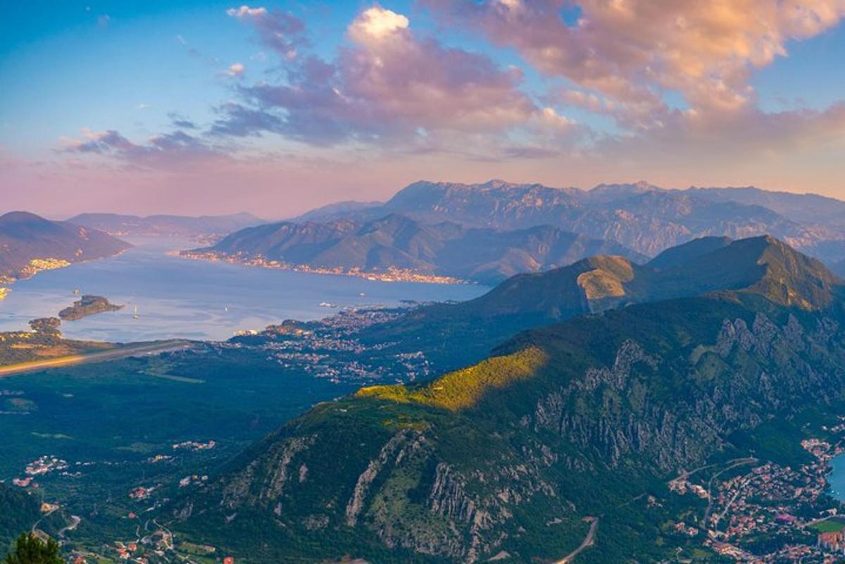 a view of a mountain with a city and a body of water