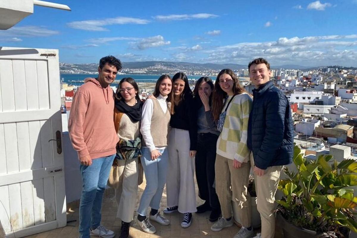 a group of people posing for a picture on a balcony