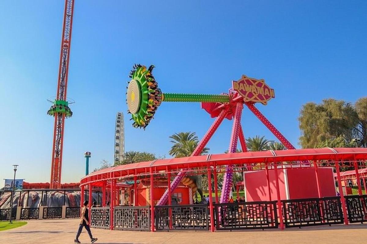 a person walks past a carnival ride at an amusement park