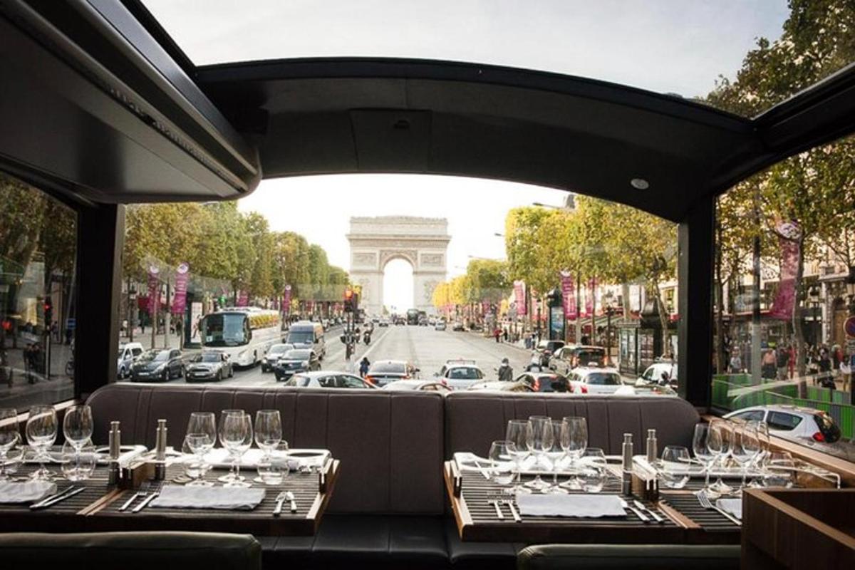 a table with wine glasses and a view of the arch
