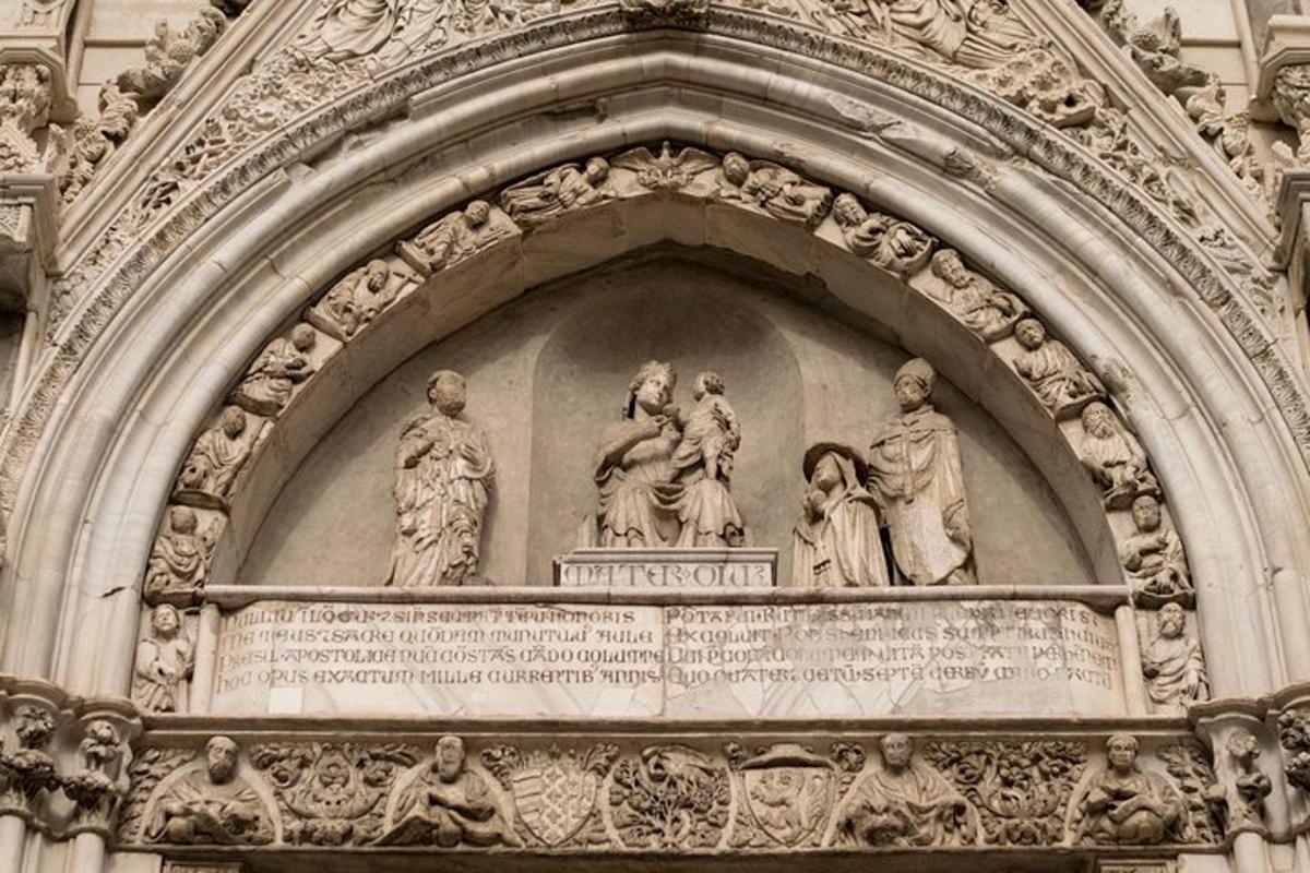 statuju grupa uz ēkas fasādes