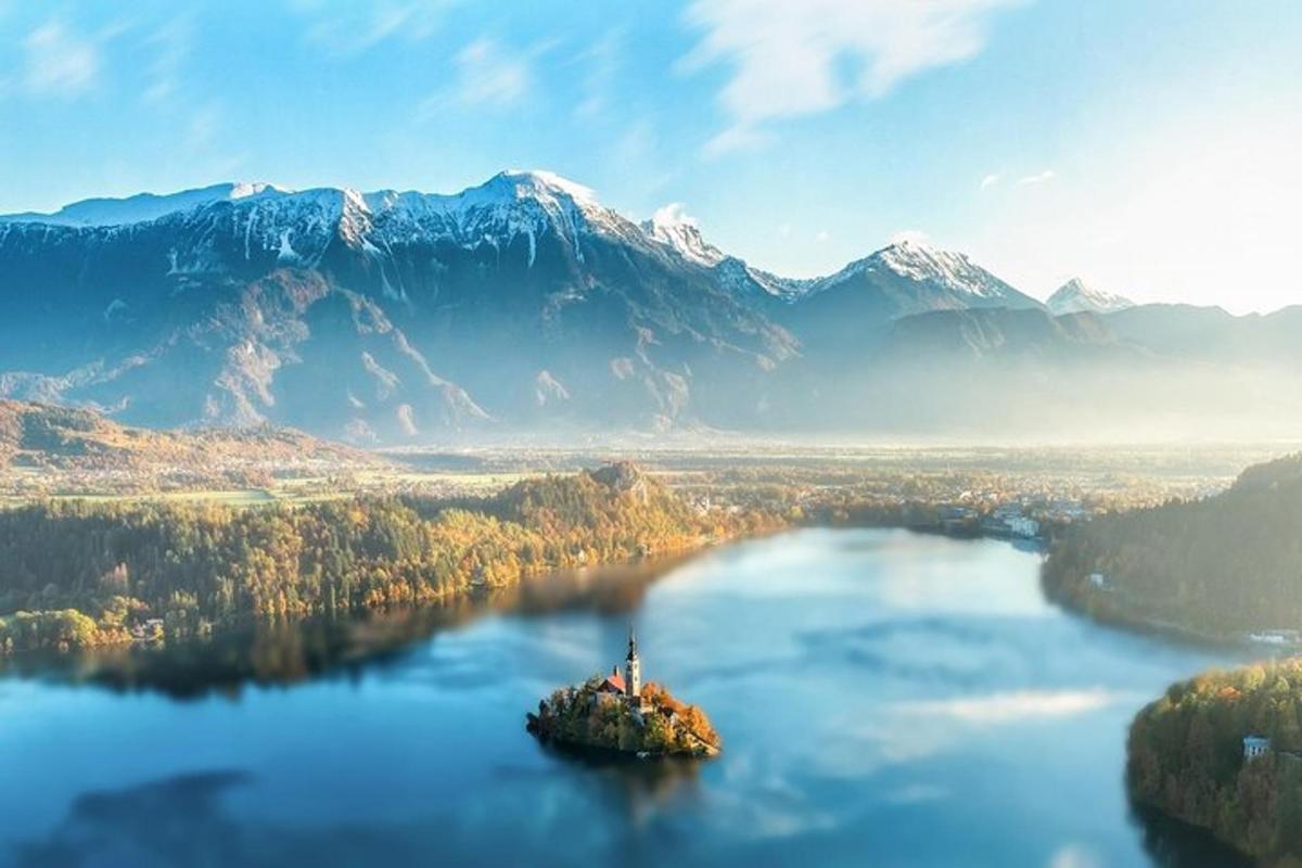 an island in the middle of a lake with mountains