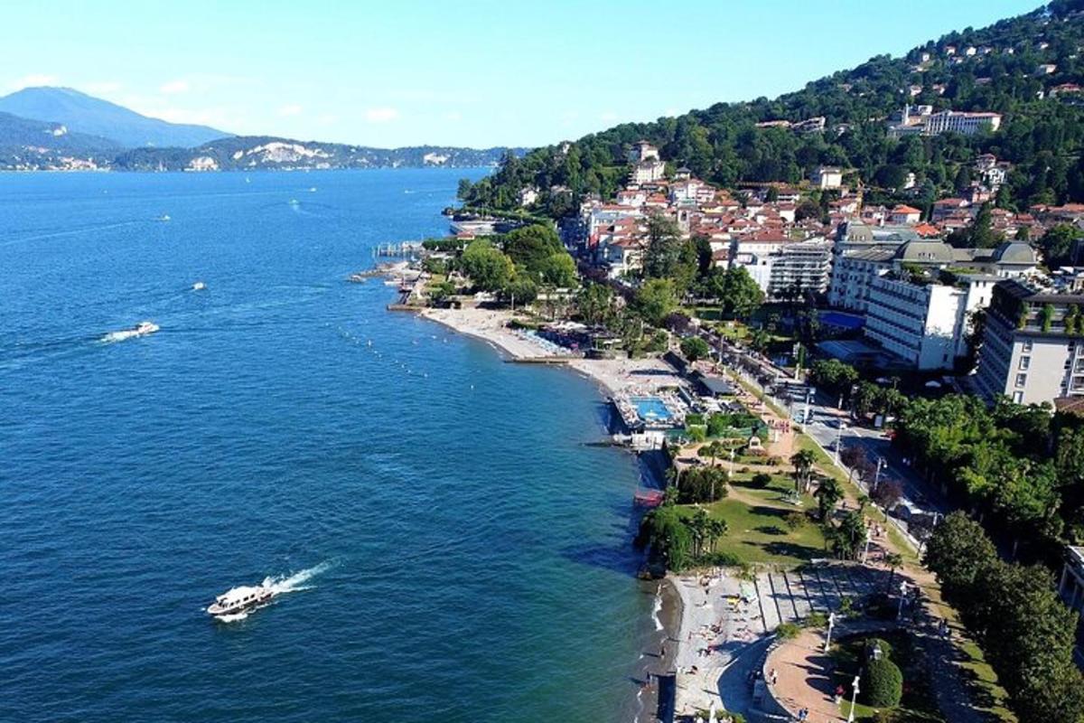 an aerial view of a beach with boats in the water