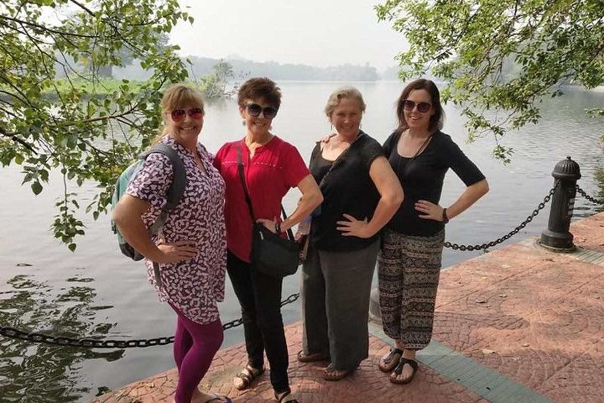 a group of women standing next to a body of water