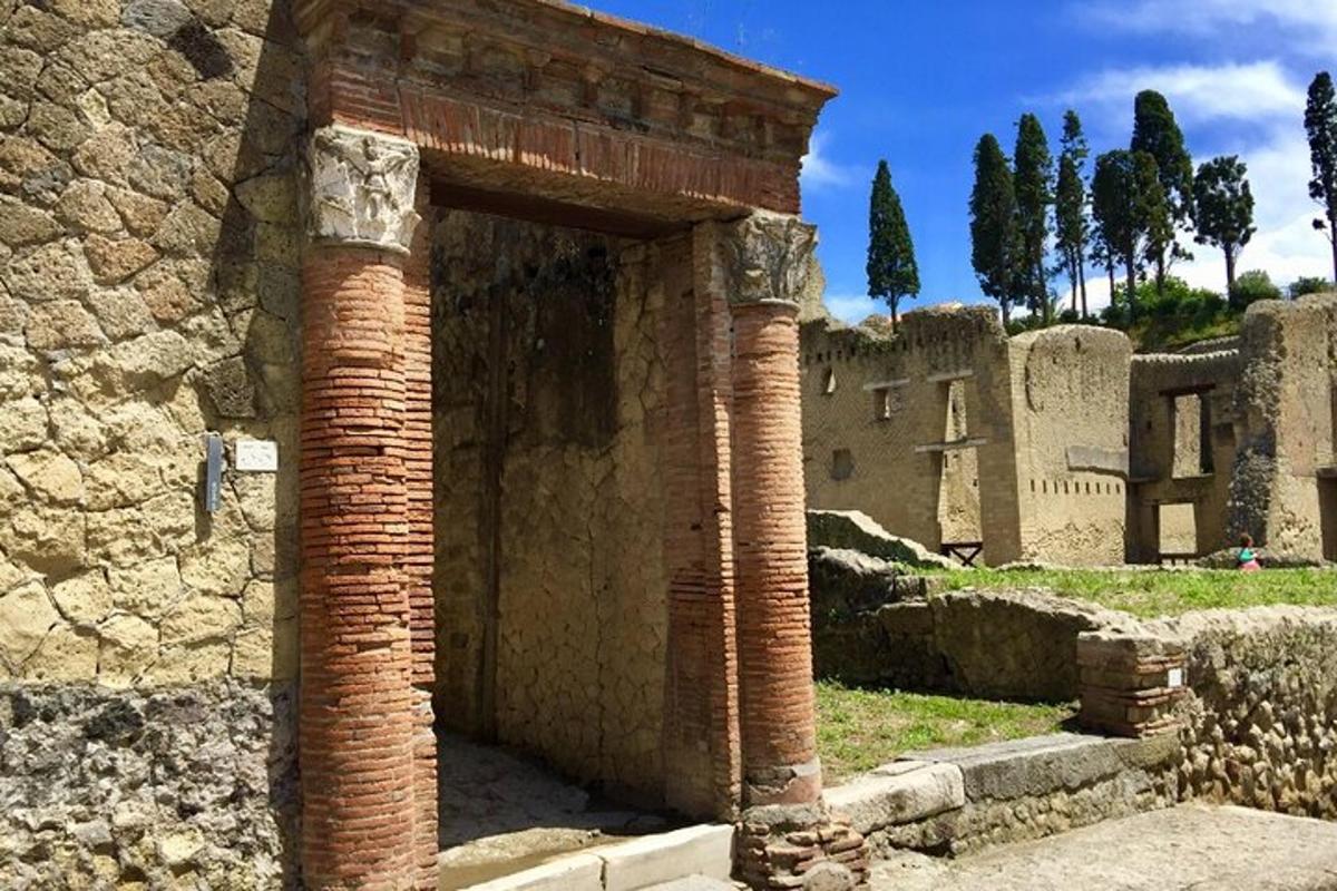 an ancient building with two brick pillars in front
