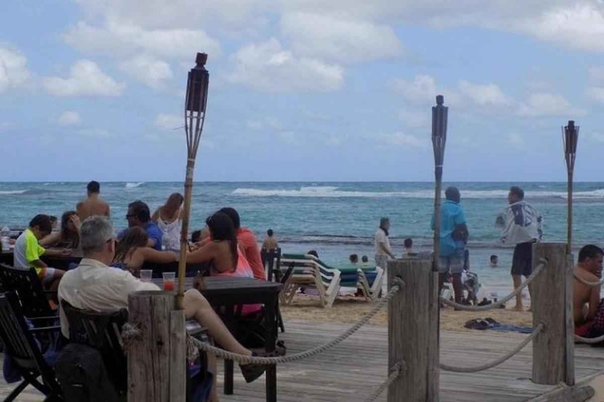 a group of people sitting at the beach