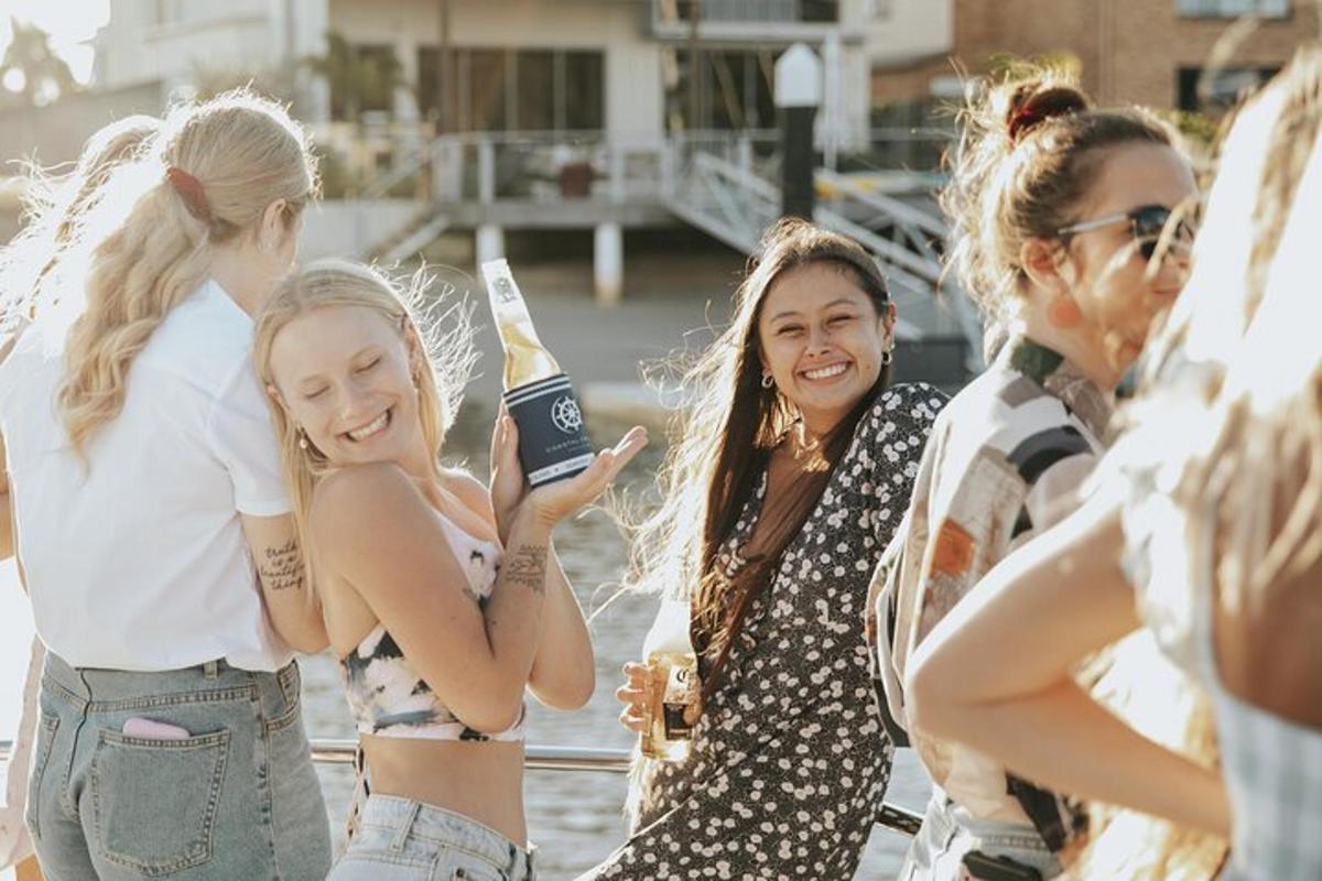 a group of girls standing on a boat taking a picture