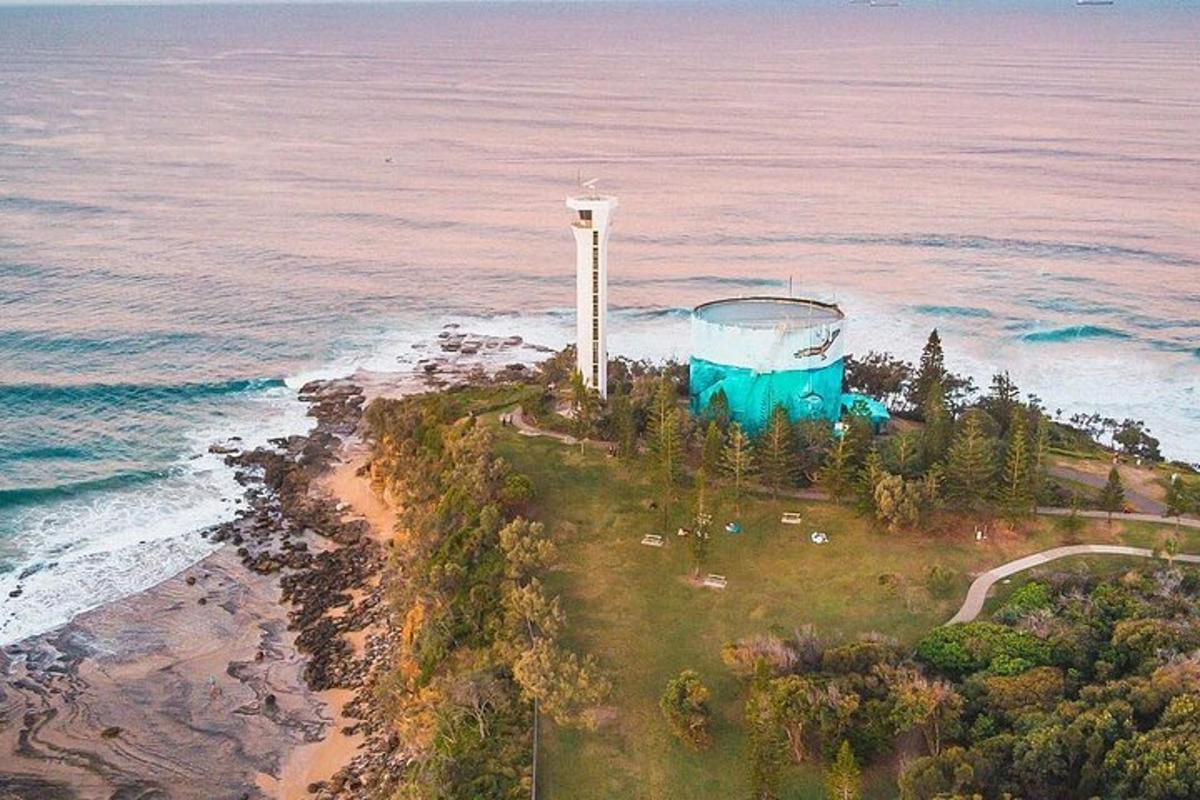 an aerial view of a lighthouse on an island in the ocean