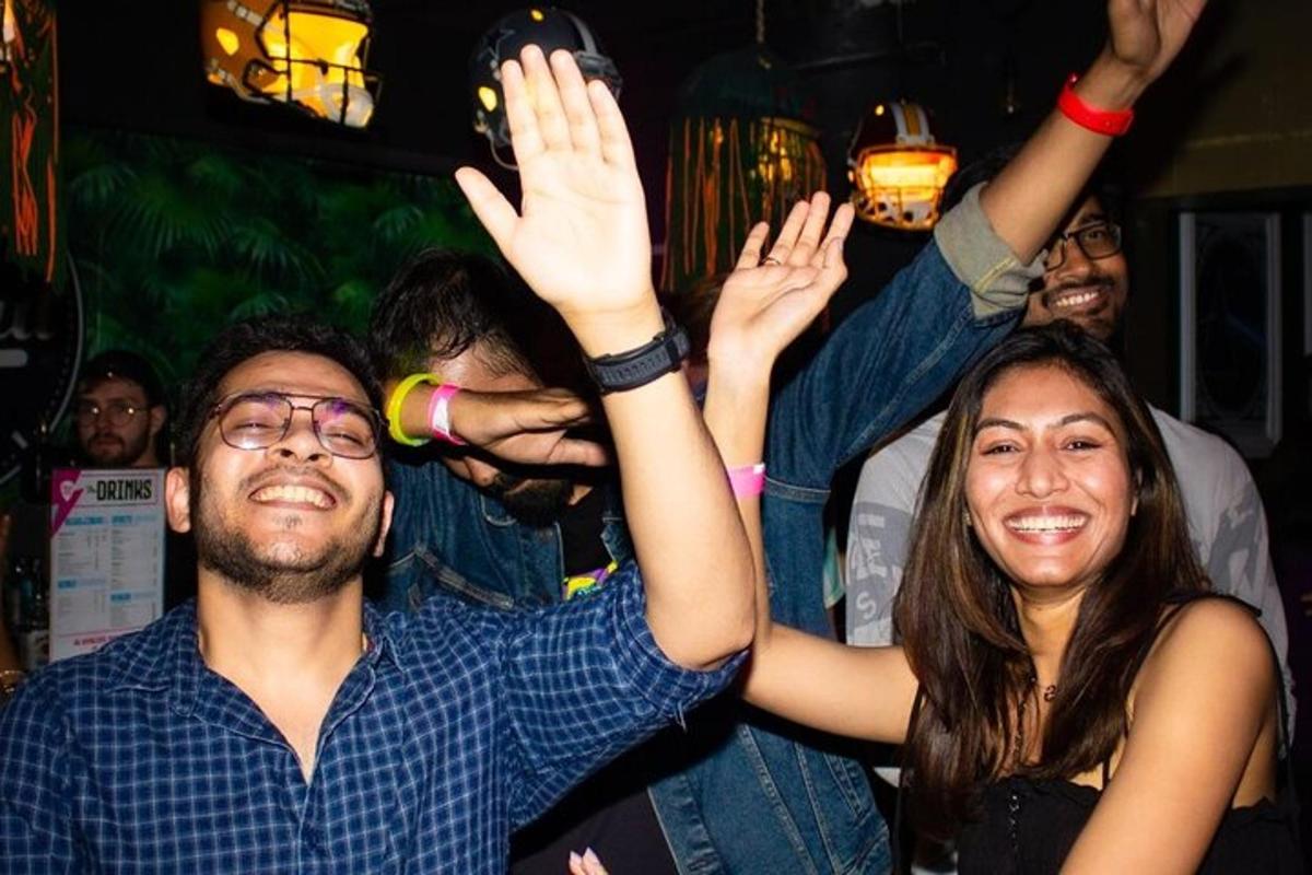 a group of people raising their hands in the air