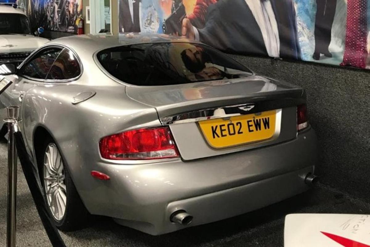 a silver car is parked in a showroom