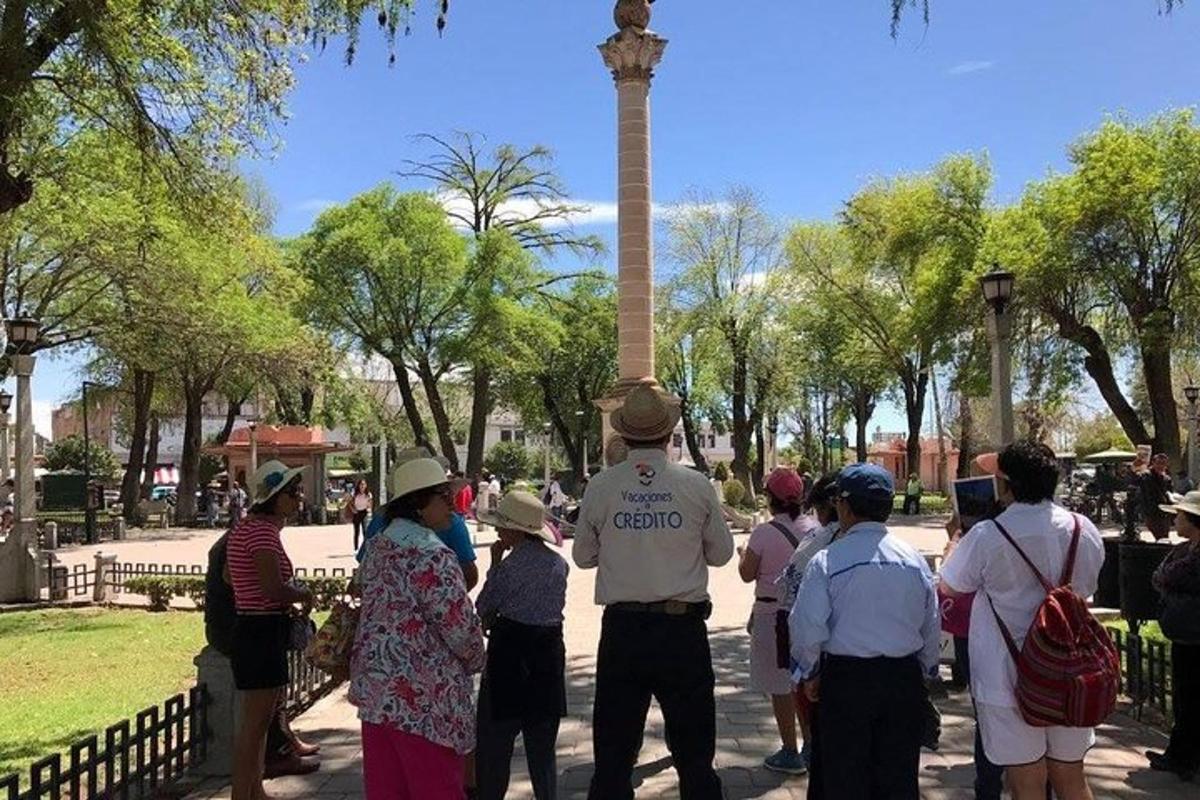 a group of people standing in front of a obelisk