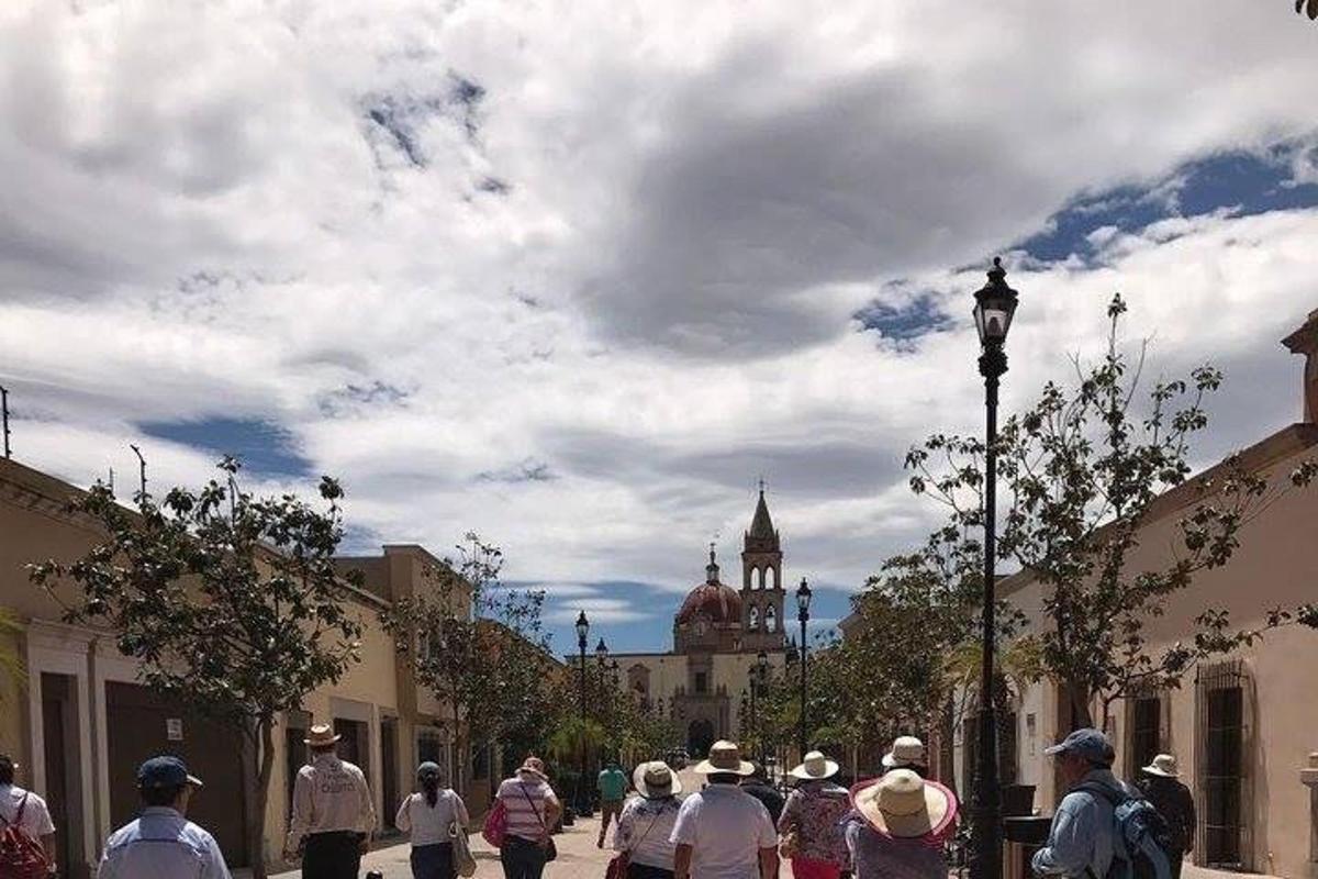 a group of people walking down a city street